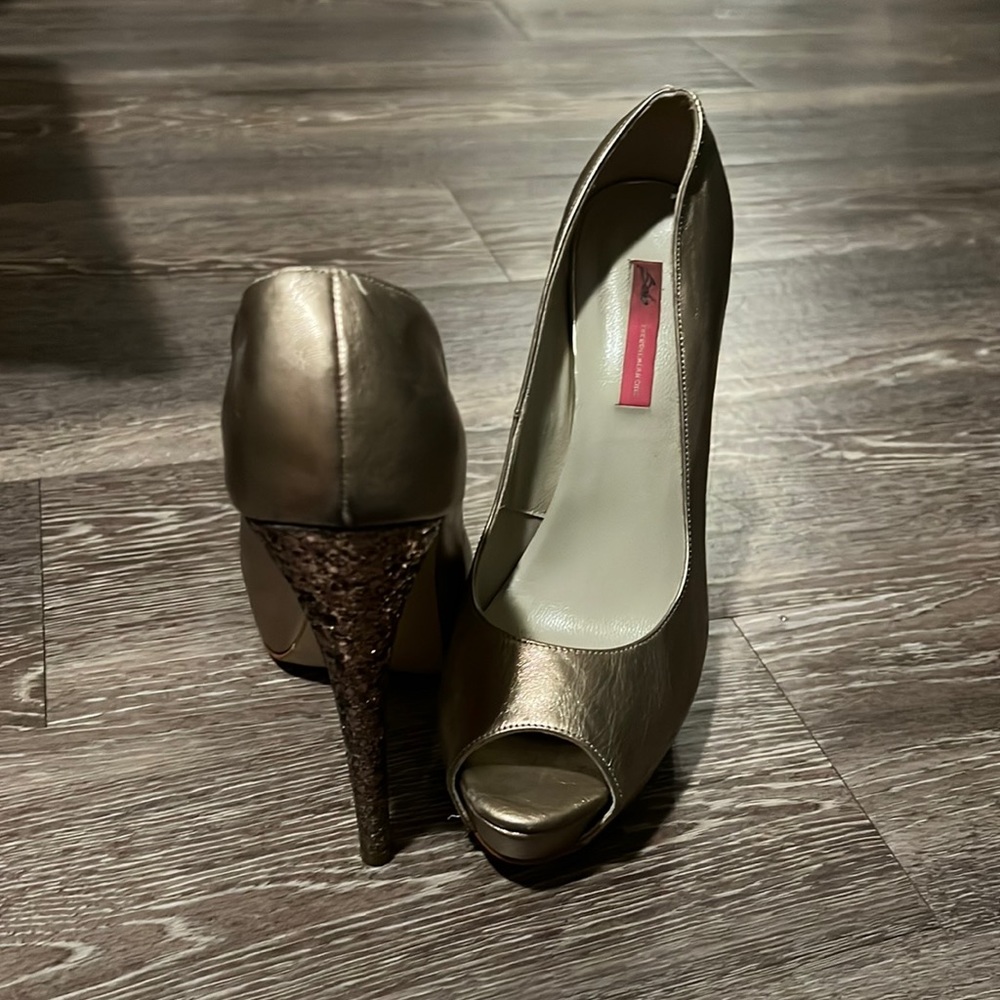 Sexy metallic pumps with glitter on heel. Beautiful bronze color